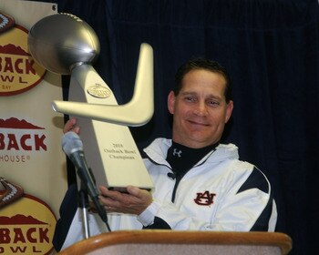 TAMPA, FL - JANUARY 1: Coach Gene Chizik of the Auburn Tigers holds the Outback trophy after an overtime victory against the Northwestern Wildcats in the Outback Bowl January 1, 2010 at Raymond James Stadium in Tampa, Florida.  (Photo by Al Messerschmidt/