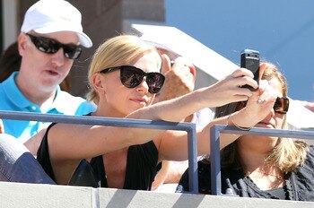 NEW YORK - SEPTEMBER 11:  Actress Charlize Theron attends the men's singles semifinal match between Rafael Nadal of Spain and Mikhail Youzhny of Russia during day thirteen of the 2010 U.S. Open at the USTA Billie Jean King National Tennis Center on Septem