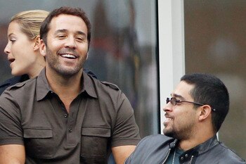 NEW YORK - SEPTEMBER 13:  Jeremy Piven and Wilmer Valderrama watch the men's singles final match between Novak Djokovic of Serbia and Rafael Nadal of Spain during day fifteen of the 2010 U.S. Open at the USTA Billie Jean King National Tennis Center on Sep