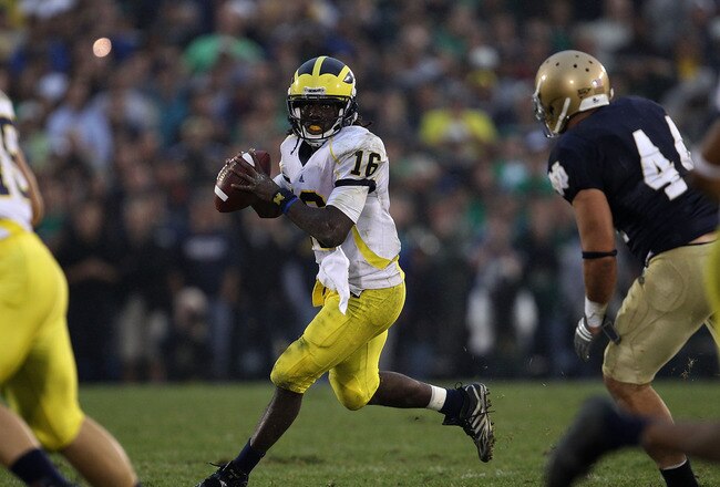 SOUTH BEND, IN - SEPTEMBER 11: Denard Robinson #16 of the Michigan Wolverines looks for a receiver under pressure from Carlo Calabrese #44 of the Notre Dame Fighting Irish at Notre Dame Stadium on September 11, 2010 in South Bend, Indiana. Michigan defeat