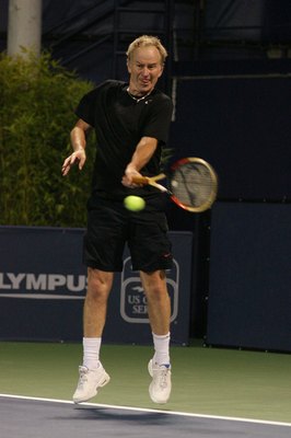 LOS ANGELES, CA - JULY 24:  John McEnroe hits a forehand shot against Andre Agassi during the Stars Under the Stars gala on July 24, 2010 at the Los Angeles Tennis Center in Los Angeles, California.  Andre Agassi defeated John McEnroe 6-4, 6-2.  (Photo by