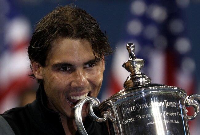 NEW YORK - SEPTEMBER 13:  Rafael Nadal of Spain bites the championship trophy during the trophy ceremony after defeating Novak Djokovic of Serbia to win the men's singles final on day fifteen of the 2010 U.S. Open at the USTA Billie Jean King National Ten