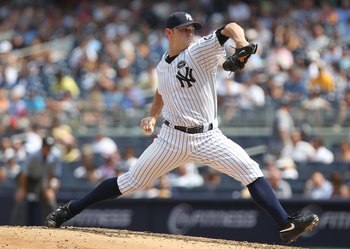 NEW YORK - JULY 21:  David Robertson #30 of the New York Yankees pitches against the Los Angeles Angels of Anaheim at Yankee Stadium on July 21, 2010 in the Bronx borough of New York City.  (Photo by Nick Laham/Getty Images)