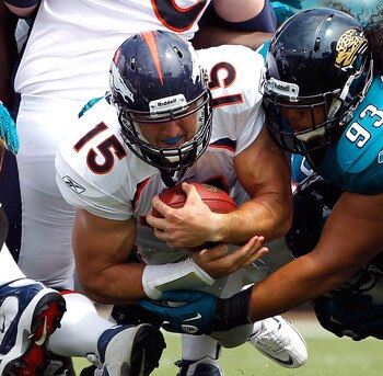 JACKSONVILLE, FL - SEPTEMBER 12:  Tyson Alualu #93 of the Jacksonville Jaguars tackles Tim Tebow #15 of the Denver Broncos during the NFL season opener game at EverBank Field on September 12, 2010 in Jacksonville, Florida.  (Photo by Sam Greenwood/Getty I