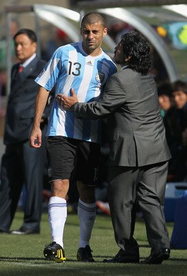 JOHANNESBURG, SOUTH AFRICA - JUNE 17:  Diego Maradona head coach of Argentina consoles the injured Walter Samuel of Argentina during the 2010 FIFA World Cup South Africa Group B match between Argentina and South Korea at Soccer City Stadium on June 17, 20