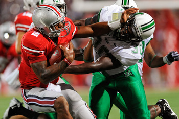 COLUMBUS, OH - SEPTEMBER 2:  Terrelle Pryor #2 of the Ohio State Buckeyes stiff arms Mario Harvey #30 of the Marshall Thundering Herd at Ohio Stadium on September 2, 2010 in Columbus, Ohio.  (Photo by Jamie Sabau/Getty Images)