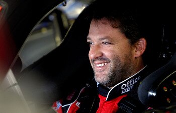 LOUDON, NH - SEPTEMBER 18:  Tony Stewart, driver of the #14 Office Depot / Old Spice Chevrolet, smiles as he sits in his car during practice for the NASCAR Sprint Cup Series Sylvania 300 at New Hampshire Motor Speedway on September 18, 2010 in Loudon, New