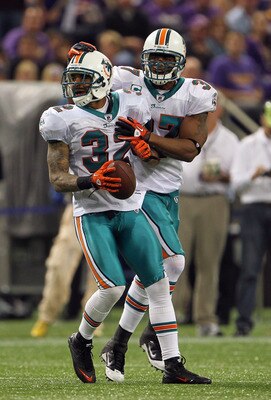 MINNEAPOLIS - SEPTEMBER 19:  Jason Allen #32 of the Miami Dolphins is congratulated by Yeremiah Bell #37 after an interception during the game on September 19, 2010 at Hubert H. Humphrey Metrodome in Minneapolis, Minnesota.  (Photo by Jamie Squire/Getty I
