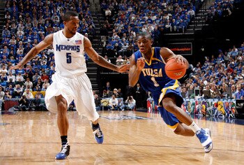 MEMPHIS, TN - MARCH 14:  Ben Uzoh #1 of the Tulsa Golden Hurricane drives around Antonio Anderson #5 of the Memphis Tigers during the Championship of the Conference USA Basketball Tournament at FedExForum on March 14, 2009 in Memphis, Tennessee.  Memphis