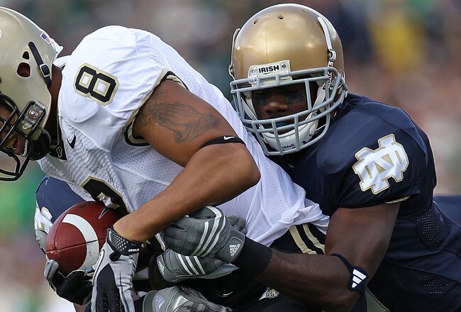 SOUTH BEND, IN - SEPTEMBER 04: Keith Smith #8 of the Purdue Boilermakers is stopped by Darrin Walls #2 (R) and Jamoris Slaughter #26 of the Notre Dame Fighting Irish at Notre Dame Stadium on September 4, 2010 in South Bend, Indiana. (Photo by Jonathan Dan