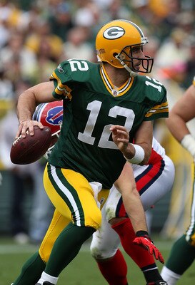 GREEN BAY, WI - SEPTEMBER 19: Aaron Rodgers #12 of the Green Bay Packers rolls out to look for a receiver against the Buffalo Bills at Lambeau Field on September 19, 2010 in Green Bay, Wisconsin. The Packers defeated the Bills 34-7. (Photo by Jonathan Dan