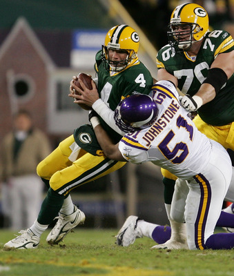 GREEN BAY, WI - NOVEMBER 21:  Quarterback Brett Favre #4 of the Green Bay Packers is sacked by Lance Johnstone #51 of the Minnesota Vikings as Chad Clifton #76 tries to block in NHL action November 21, 2005 at Lambeau Field in Green Bay, Wisconsin.  (Phot