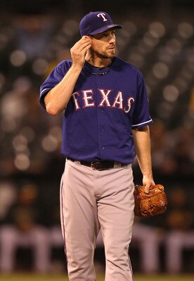 OAKLAND, CA - SEPTEMBER 23:  Cliff Lee #33 of the Texas Rangers holds his ear after a single by Jack Cust of the Oakland Athletics in the fourth inning during a Major League Baseball game at the Oakland-Alameda County Coliseum on September 23, 2010 in Oak