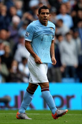 MANCHESTER, ENGLAND - SEPTEMBER 25:  Carlos Tevez of Manchester City shows off a message on his T-Shirt after scoring the opening goal during the Barclays Premier League match between Manchester City and Chelsea at the City of Manchester Stadium on Septem