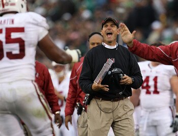 SOUTH BEND, IN - SEPTEMBER 25: Head coach Jim Harbaugh of the Stanford Cardinal smiles at Jonathan Martin #55 after a play against the Notre Dame Fighting Irish at Notre Dame Stadium on September 25, 2010 in South Bend, Indiana. Stanford defeated Notre Da