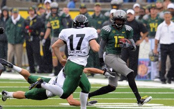 EUGENE, OR - SEPTEMBER 18: Cornerback Cliff Harris #13 of the Oregon Ducks returns a punt as punter Robert Truax #17 of the Portland State Vikings closes in during the first quarter of the game at Autzen Stadium on September 18, 2010 in Eugene, Oregon. Or