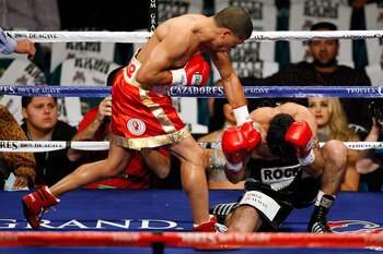 LAS VEGAS - DECEMBER 06:  (L-R) Juan Manuel Lopez of Puerto Rico connects a left to the head of Sergio Medina of Argentina during their WBO junior featherweight title fight at the MGM Grand Garden Arena December 6, 2008 in Las Vegas, Nevada.  (Photo by Et
