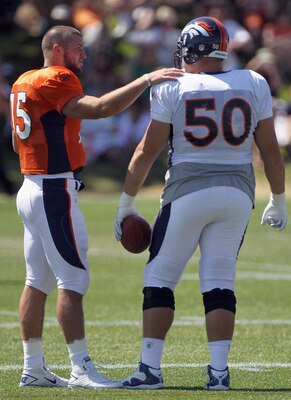 Tim Tebow prepares a teammate for baptism.