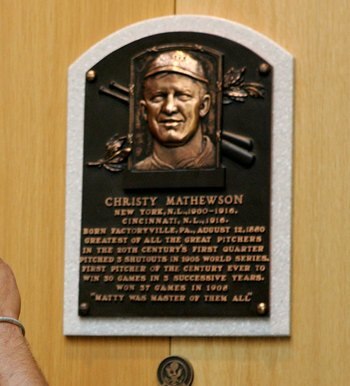 COOPERSTOWN, NY - JULY 29:  A baseball fan photograghs the plaque of Christy Mathewson at the National Baseball Hall of Fame and Museum during the Baseball Hall of Fame weekend on July 29, 2006 in Cooperstown, New York.  (Photo by Jim McIsaac/Getty Images