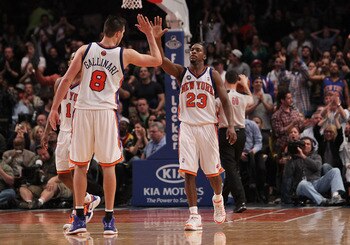 NEW YORK - MARCH 19: Toney Douglas #23 of the New York Knicks celebrates a basket with teammate Danilo Gallinari #8 against the Philadelphia 76ers at Madison Square Garden on March 19, 2010 in New York City. NOTE TO USER: User expressly acknowledges and a
