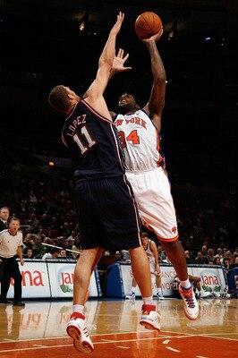 NEW YORK - OCTOBER 24:  Brook Lopez #11 of the New Jersey Nets tries to block a shot by Eddy Curry #34 of the New York Knicks during the first half of a preseason game on October 24, 2008 at Madison Square Garden in New York City. NOTE TO USER: User expre