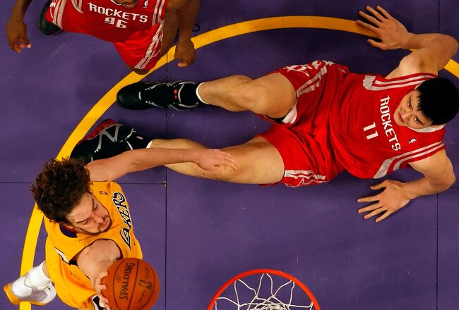 LOS ANGELES, CA - MAY 04:  Pau Gasol #16 of the Los Angeles Lakers goes up for a shot as Yao Ming #11 and Ron Artest #96 of the Houston Rockets look on in Game One of the Western Conference Semifinals during the 2009 NBA Playoffs at Staples Center on May