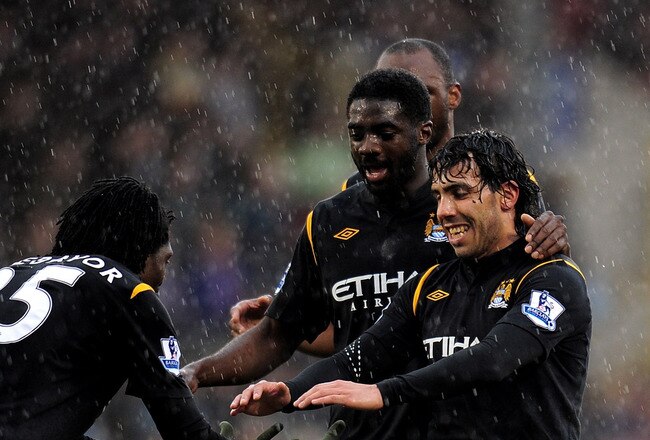 BURNLEY, ENGLAND - APRIL 03:  Emmanuel Adebayor of Manchester City celebrates scoring his team's fifth goal with team mate Carlos Tevez during the Barclays Premier League match between Burnley and Manchester City at Turf Moor on April 3, 2010 in Burnley,