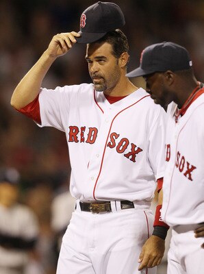 BOSTON - APRIL 04:  Mike Lowell #25 of the Boston Red Sox tips his hat to the fans during player introductions before the game against the New York Yankees on April 4, 2010 during Opening Night at Fenway Park in Boston, Massachusetts.  (Photo by Elsa/Gett