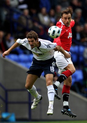 BOLTON, ENGLAND - SEPTEMBER 26:  Sam Ricketts of Bolton Wanderers competes with Dimitar Berbatov of Manchester United during the Barclays Premier League match between Bolton Wanderers and Manchester United at the Reebok Stadium on September 26, 2010 in Bo