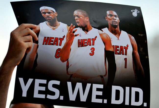 MIAMI - JULY 09:  A fan holds up a poster  of Chris Bosh #1, Dwyane Wade #3 and LeBron James #6 of the Miami Heat before the start of a welcome party for the new players at American Airlines Arena on July 9, 2010 in Miami, Florida.  (Photo by Doug Benc/Ge