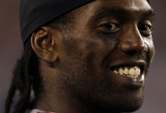 FOXBORO, MA - AUGUST 12: Randy Moss # 81 of the New England Patriots chats with teammates on the sidelines during the preseason game against the New Orleans Saints at Gillette Stadium on August 12, 2010 in Foxboro, Massachusetts. (Photo by Jim Rogash/Gett