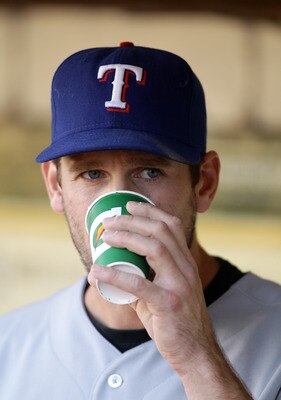 OAKLAND, CA - AUGUST 06:  Cliff Lee #33 of the Texas Rangers drinks Gatorade in the dugout before their game against the Oakland Athletics at the Oakland-Alameda County Coliseum on August 6, 2010 in Oakland, California.  (Photo by Ezra Shaw/Getty Images)