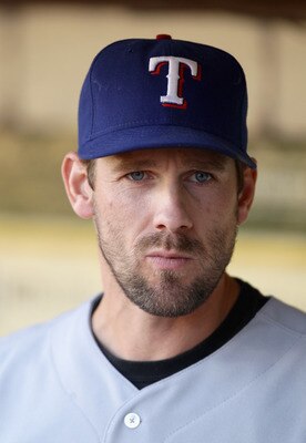 OAKLAND, CA - AUGUST 06:  Cliff Lee #33 of the Texas Rangers stands in the dugout before their game against the Oakland Athletics at the Oakland-Alameda County Coliseum on August 6, 2010 in Oakland, California.  (Photo by Ezra Shaw/Getty Images)