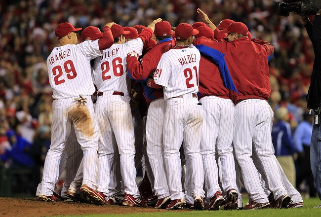 PHILADELPHIA - OCTOBER 06:  Roy Halladay #34 of the Philadelphia Phillies is mobbed by teammates after pitching a no-hitter and the win in Game 1 of the NLDS against the Cincinnati Reds at Citizens Bank Park on October 6, 2010 in Philadelphia, Pennsylvani