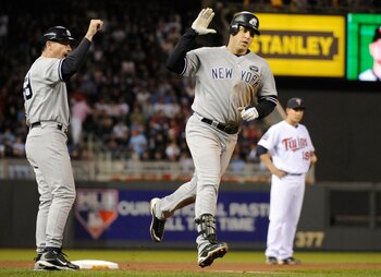 MINNEAPOLIS, MN - OCTOBER 6: Mark Teixeira #25 of the New York Yankees celebrates a two-run home run with third base coach Rob Thomson #59 during game one of the ALDS against the Minnesota Twins on October 6, 2010 at Target Field in Minneapolis, Minnesota