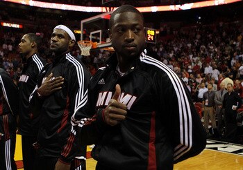 MIAMI - OCTOBER 05:  Forward LeBron James #6 (C) and teammate Dwyane Wade #3 (R) on the court before taking on the Detroit Pistons on October 5, 2010 in Miami, Florida.  NOTE TO USER: User expressly acknowledges and agrees that, by downloading and or usin