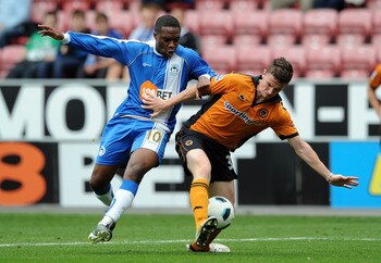 WIGAN, ENGLAND - OCTOBER 02: Charles N'Zogbia of Wigan Athletic competes with Kevin Foley of Wolverhampton Wanderers during the Barclays Premier League match between Wigan Athletic and Wolverhampton Wanderers at DW Stadium on October 2, 2010 in Wigan, Eng