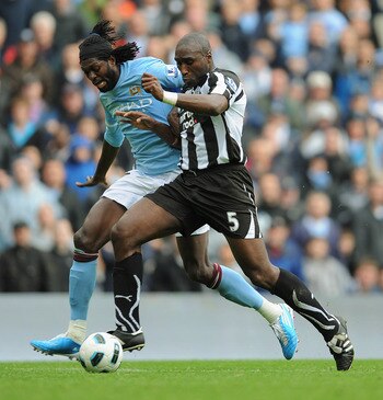MANCHESTER, ENGLAND - OCTOBER 03:  Emmanuel Adebayor of Manchester City in action with Sol Campbell of Newcastle during the Barclays Premier League match between Manchester City and Newcastle United at the City of Manchester Stadium on October 3, 2010 in 