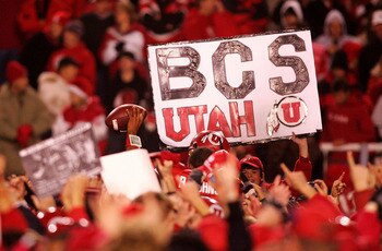 SALT LAKE CITY - NOVEMBER 22:  A fan of the Utah Utes holds a a sign after defeating the BYU Cougars 48-24 to complete a pefect 12-0 season at Rice-Eccles Stadium on November 22, 2008 in Salt Lake City, Utah.  (Photo by Jonathan Ferrey/Getty Images)