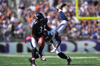 BALTIMORE, MD - OCTOBER 10:  Fabian Washington #31 of the Baltimore Ravens breaks up a pass intended for Brandon Lloyd #84 of the Denver Broncos at M&T Bank Stadium on October 10, 2010 in Baltimore, Maryland. Players wore pink in recognition of Breast Can