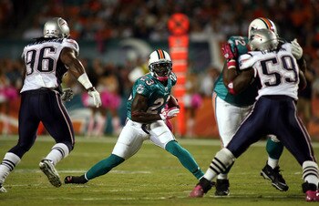 MIAMI - OCTOBER 04:  Running back Ronnie Brown #23 of the Miami Dolphins runs against the New England Patriots at Sun Life Stadium on October 4, 2010 in Miami, Florida.  (Photo by Marc Serota/Getty Images)