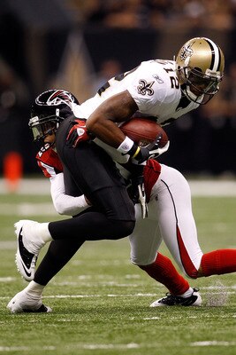 NEW ORLEANS - SEPTEMBER 26:  Marques Colston #12 of the New Orleans Saints is tackled by Brent Grimes #20 of the Atlanta Falcons at the Louisiana Superdome on September 26, 2010 in New Orleans, Louisiana.  The Falcons defeated the Saints 27-24.  (Photo by