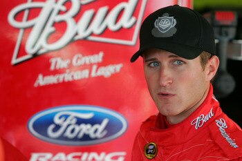 KANSAS CITY, KS - OCTOBER 01:  Kasey Kahne, driver of the #9 Budweiser Ford, stands in the garage during practice for the NASCAR Sprint Cup Series Price Chopper 400 on October 1, 2010 in Kansas City, Kansas.  (Photo by Jerry Markland/Getty Images for NASC