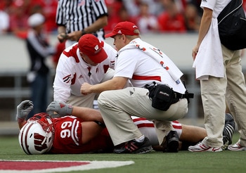 MADISON, WI - SEPTEMBER 18: J.J. Watt #99 of the Wisconsin Badgers is attended to by trainers after suffering an injury against the Arizona State Sun Devils at Camp Randall Stadium on September 18, 2010 in Madison, Wisconsin. Wisconsin defeated Arizona St