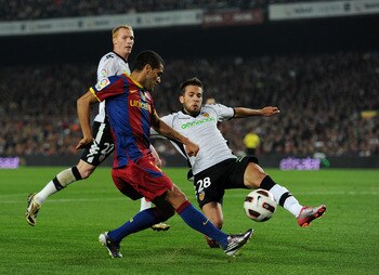BARCELONA, SPAIN - OCTOBER 16:  Daniel Alves (L) of Barcelona tries to score past Jordi Alba of Valencia during the La Liga match between Barcelona and Valencia at the Camp Nou stadium on October 16, 2010 in Barcelona, Spain. Barcelona won the match 2-1. 