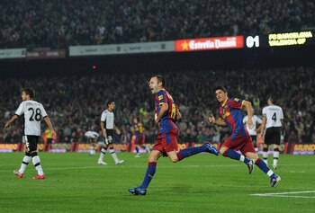 BARCELONA, SPAIN - OCTOBER 16:  Andres Iniesta (L) of Barcelona celebrates scoring his sides equalizing goal with his teammate David Villa during the La Liga match between Barcelona and Valencia at the Camp Nou stadium on October 16, 2010 in Barcelona, Sp