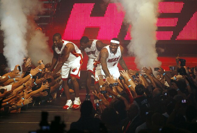 MIAMI - JULY 09:  Fans cheer as (L-R) Dwyane Wade #3, Chris Bosh #1 and LeBron James #6 of the Miami Heat are introduced during a welcome party at American Airlines Arena on July 9, 2010 in Miami, Florida.  (Photo by Marc Serota/Getty Images)