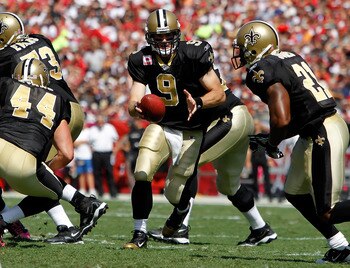 TAMPA, FL - OCTOBER 17:  Quarterback Drew Brees #9 of the New Orleans Saints hands the ball off against the Tampa Bay Buccaneers during the game at Raymond James Stadium on October 17, 2010 in Tampa, Florida.  (Photo by J. Meric/Getty Images)