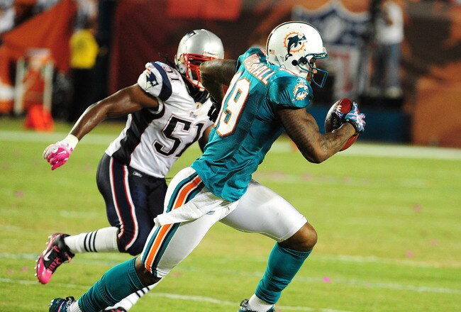 MIAMI - OCTOBER 4: Brandon Marshall #19 of the Miami Dolphins runs with a catch against the New England Patriots at Sun Life Field on October 4, 2010 in Miami, Florida. (Photo by Scott Cunningham/Getty Images)