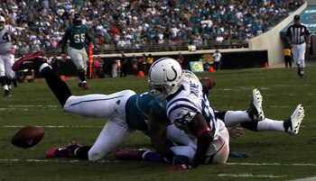 JACKSONVILLE, FL - OCTOBER 03:  Receiver Reggie Wayne #87 of the Indianapolis Colts fumbles against the Jacksonville Jaguars at EverBank Field on October 3, 2010 in Jacksonville, Florida. The Jaguars won 31-28.  (Photo by Marc Serota/Getty Images)